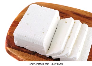 White Goat Cheese Block On Wooden Board