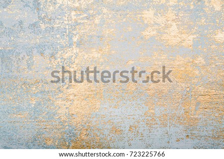 White and golden messy wall stucco texture background. Decorative wall paint.