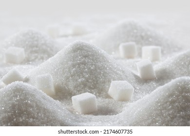 White granulated sugar and refined sugar cubes close-up