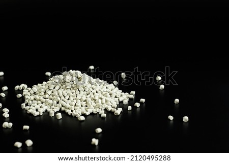 white granules of polypropylene, polyamide in a test tube. Background. Plastic and polymer industry. Microplastic products.