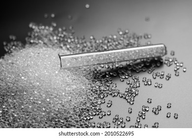 White Granules Of Rubber And Polypropylene On A Black Background In A Chemical Test Tube. Plastics And Polymers Industry.