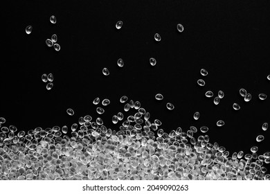 White granules of rubber, polypropylene or polyamide on a black background.