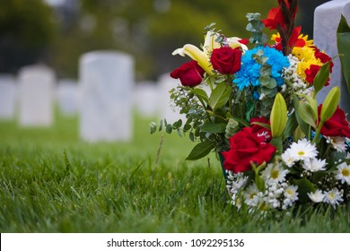 white grave markers and flowers at a national cemetary