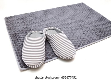 White And Gray Strip Color Slippers On Gray Bathroom Rug