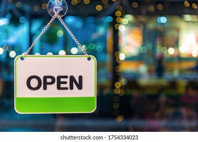 A White And Green Open Sign Hanging On Glass Coffee Shop Door At Night, Food Drink And Business Service Concept