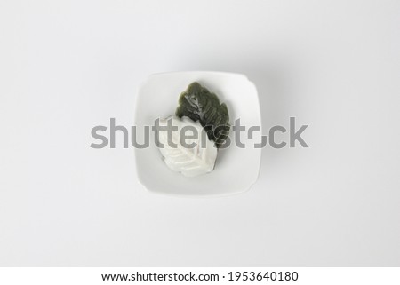 White and green rice cake isolated on white background
