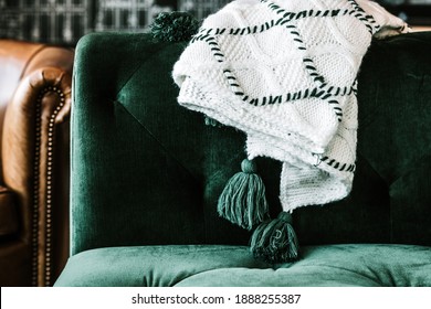 White And Green Throw Blanket On The Arm Of A Green Velvet Couch