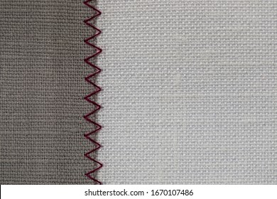 White And Grey Fabric Stitched With A Zigzag Purple Thread. Stitched Pieces Of Fabric Close-up. Zigzag Stitch.