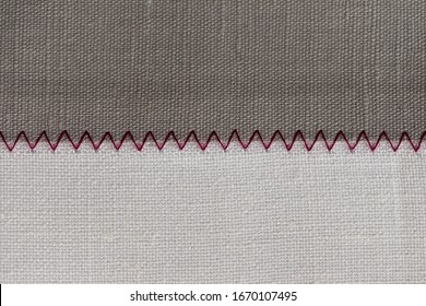 White And Grey Fabric Stitched With A Zigzag Purple Thread. Stitched Pieces Of Fabric Close-up. Zigzag Stitch.