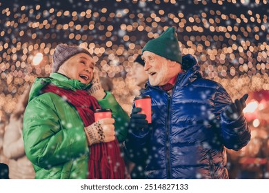 White grey hair dream two old people woman man have x-mas christmas date speak talk funny jokes hold takeout beverage eggnog mug under lights outdoors - Powered by Shutterstock