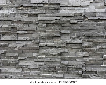 White and Grey Layer Sand Stone Wall Background Texture for wall of home.With copy sapce for your text and content.