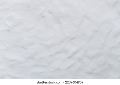 White or grey Plasticine textured background has a rough surface. Used is House wall for background or website wallpaper. By using your hand to knead it to flatten and have fingerprints attached.