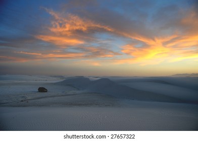 White gypsum dunes after sunset at the White Sands National Monument in New Mexico, one car visible for scale