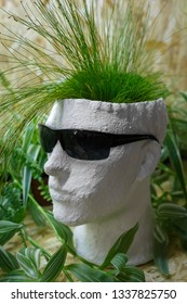 White gypsum flower pot in the shape of head of a man with black glasses