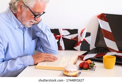 White Hair Senior Man Abandons Technology In Favor Of A Book, No More Web Addiction. Stop Laptop Tablet And Cellphone