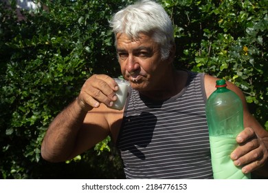 White Haired Mature Man Drinking Milk