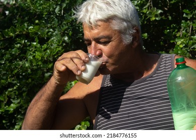 White Haired Mature Man Drinking Milk