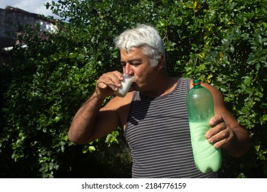 White Haired Mature Man Drinking Milk