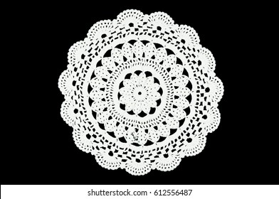 White hand made crocheted coaster lace doily on black background.  - Shutterstock ID 612556487
