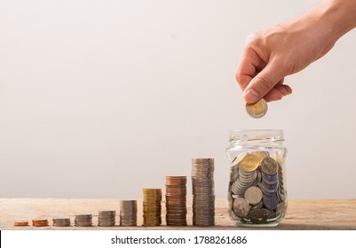 White hand man holding Gold coin to putting in Jar or glass bottle for saving with soft white background. Saving money, Saving concept - Shutterstock ID 1788261686