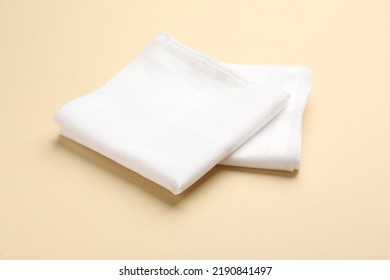 White handkerchiefs on beige background. Stylish accessory