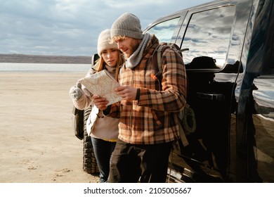 White Happy Couple Talking And Examining Paper Map During Car Trip