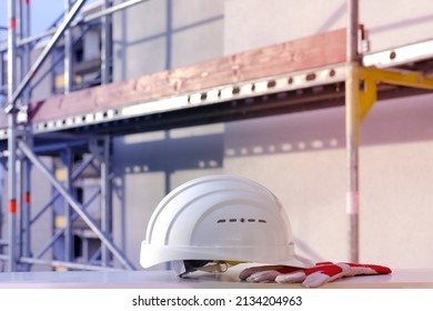 White Hardhat, Builder, Architect Helmet, Work Gloves On Scaffolding, Background Of High Buildings, Protection Inspecting At Construction Site For Building Renovation, Civil Engineering Concept