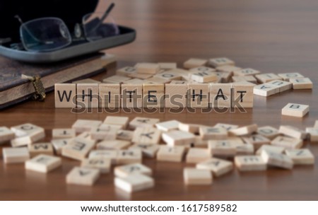 white hat hacker concept represented by wooden letter tiles