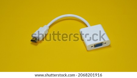 White HDMI to VGA converter cable on yellow background isolated
