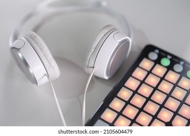 White headphones and beatbox on a gray background