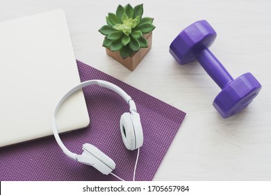 White Headphones And Dumbell On Yoga Mat. Concept Of Podcast,healthy Lifestyle,workout At Home,online Workout,home Excercise.