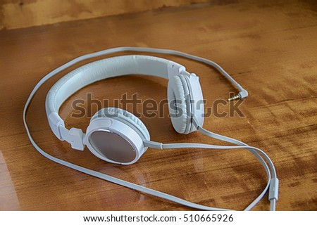 White headphones for listening to music lying on the table
