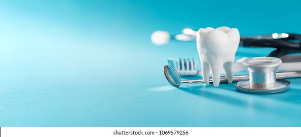 White healthy tooth, different tools for dental care. Dental background. - Shutterstock ID 1069579256