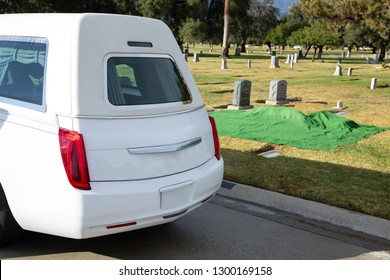 White Hearse Parked Next To A Burial Plot At A Cemetery, In A Bright Funeral Scene