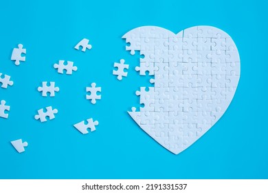 White heart shape of jigsaw puzzle pieces on blue background. concepts of problem solving, business success, teamwork, Team playing jigsaw game incomplete, Texture banner with copy space for text