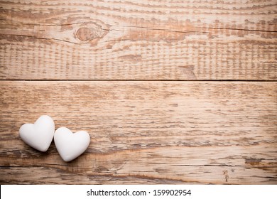 White heart and wooden  background.