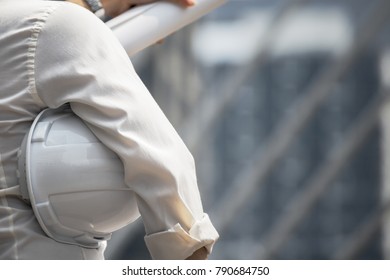 White helmet of engineer architect holding by businessman as background, back view - Shutterstock ID 790684750