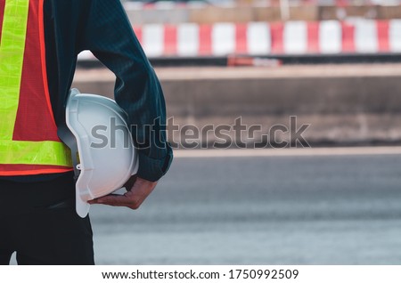 white helmet is in the hands of road construction engineers.