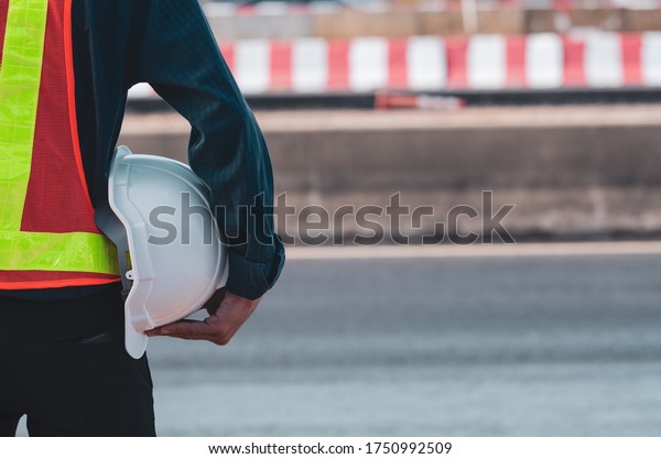 white helmet is in the hands of road\
construction engineers.