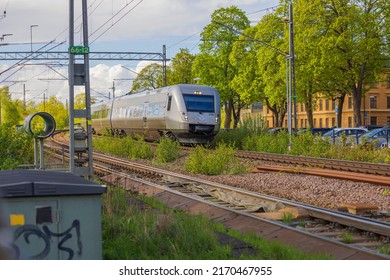 White high speed train passes through city. Transport concept. Sweden. Uppsala.06.22.2022.