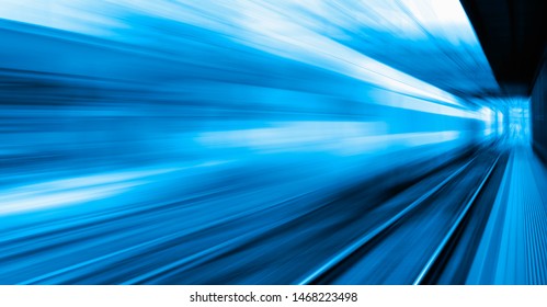 White high speed train runs on rail tracks . Train in motion