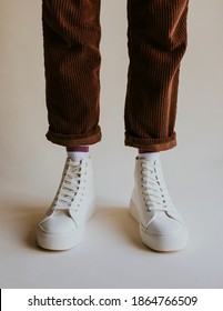 White High Top Sneakers On Corduroy Pants Model