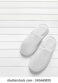 White Hotel / Home/ Spa / Wellness Slippers On Light Wooden Desk With Space For Text - Summer Sauna Time