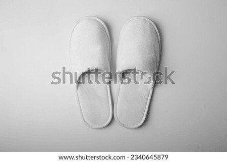 White hotel slippers on plain background