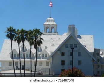 A White House In Berkeley California With The US Flag And Palm Trees.