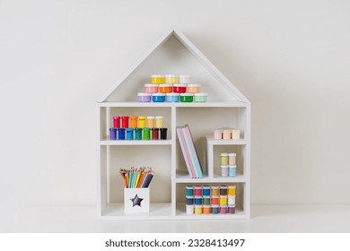 White house shaped shelving with various material for creativity and kids art activity. Stationery and supplies for drawing and craft. Organizing and storage in craft room. - Powered by Shutterstock