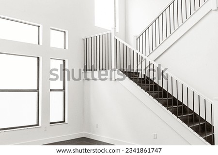 White house with white wooden staircase and big window with white color wall