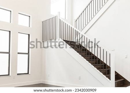 White house with white wooden staircase and big window with white color wall