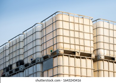 white ibc container in outdoor stock yard of factory, white plastic chemical tanks - Shutterstock ID 1643243416