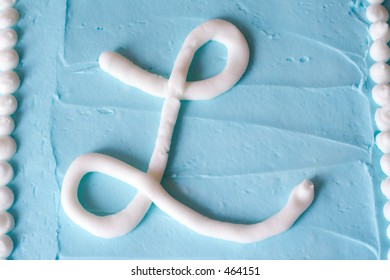 White Icing Letter L On A Blue Cake (series Spells LOVE)